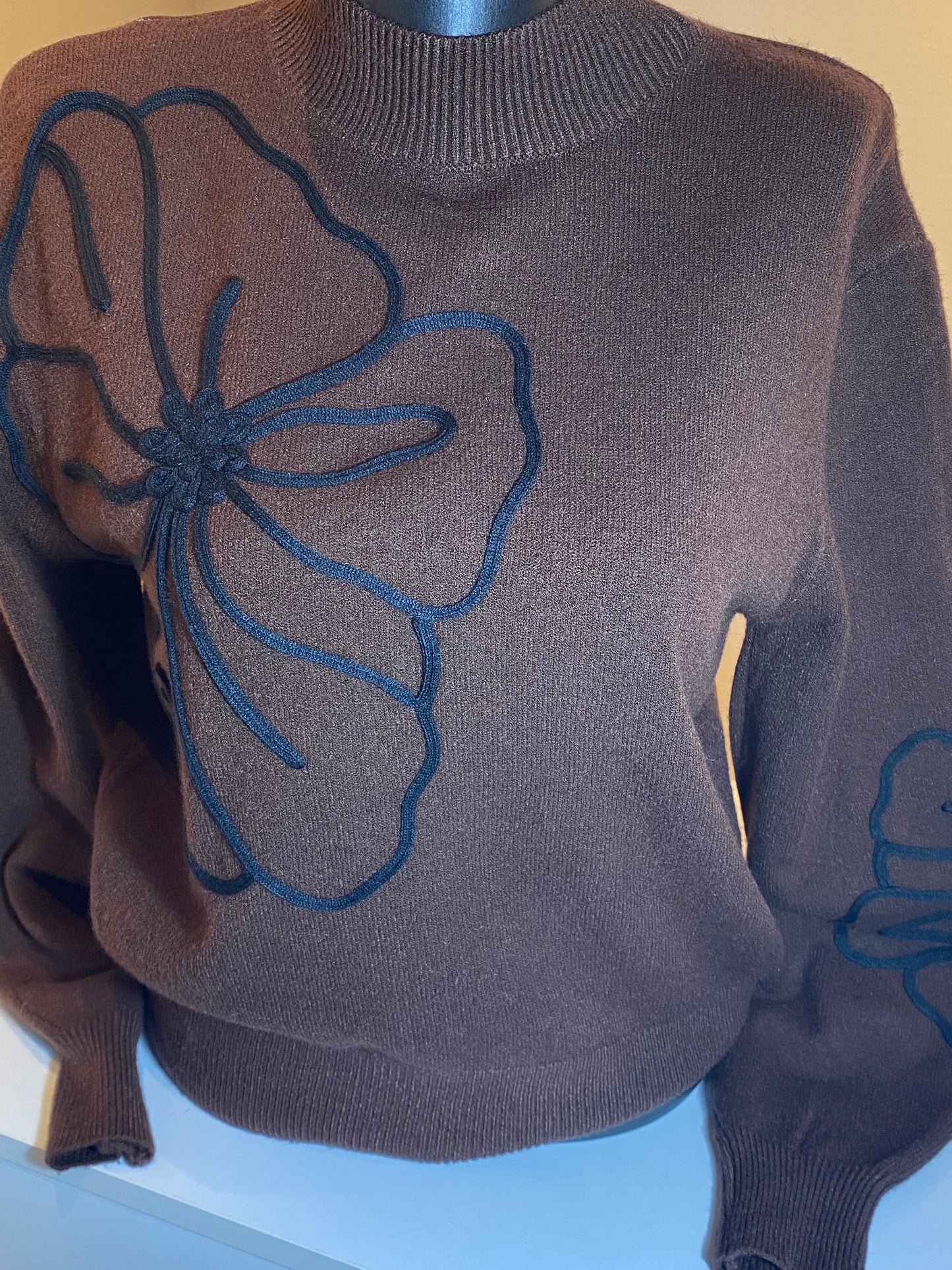 Bruine trui met zwarte bloem